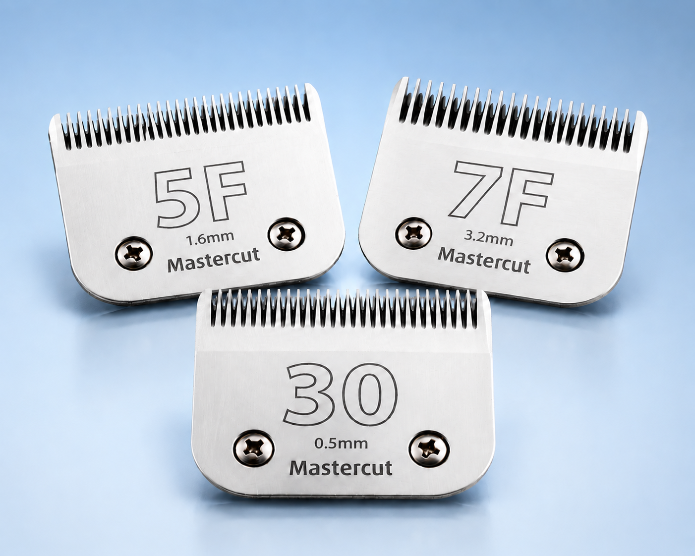 Three professional clipper blades (10, 7F, and 30) displayed on a soft blue background, representing replacement blades used for dog grooming and coat maintenance.
